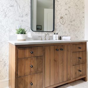 Custom wood bathroom vanity with V-Groove detail against whimsical, playful wallpaper