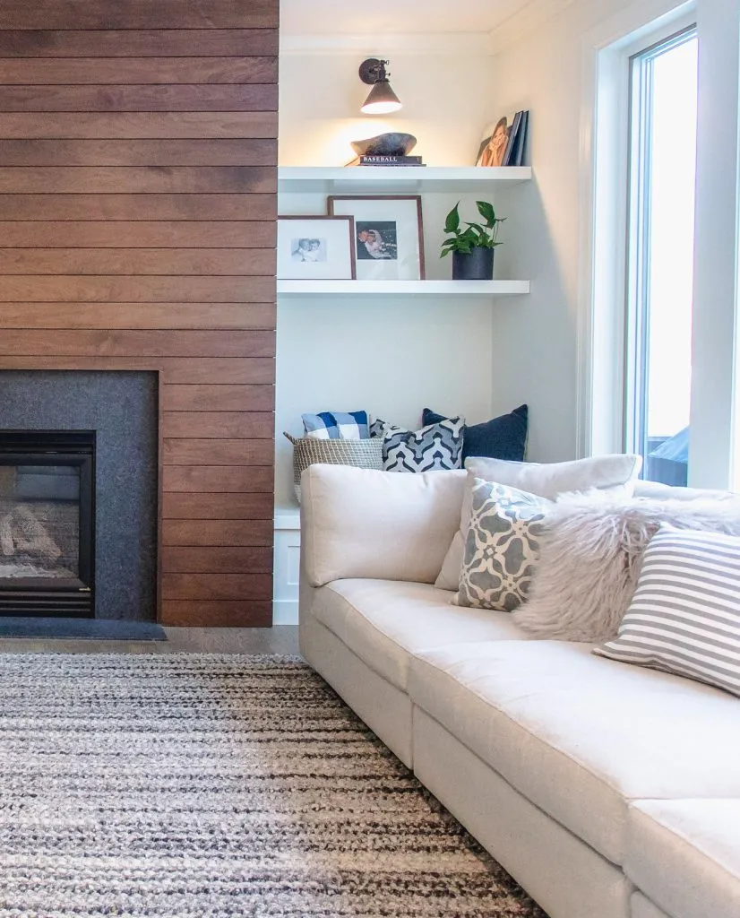 Walnut shiplap fireplace with white floating shelves