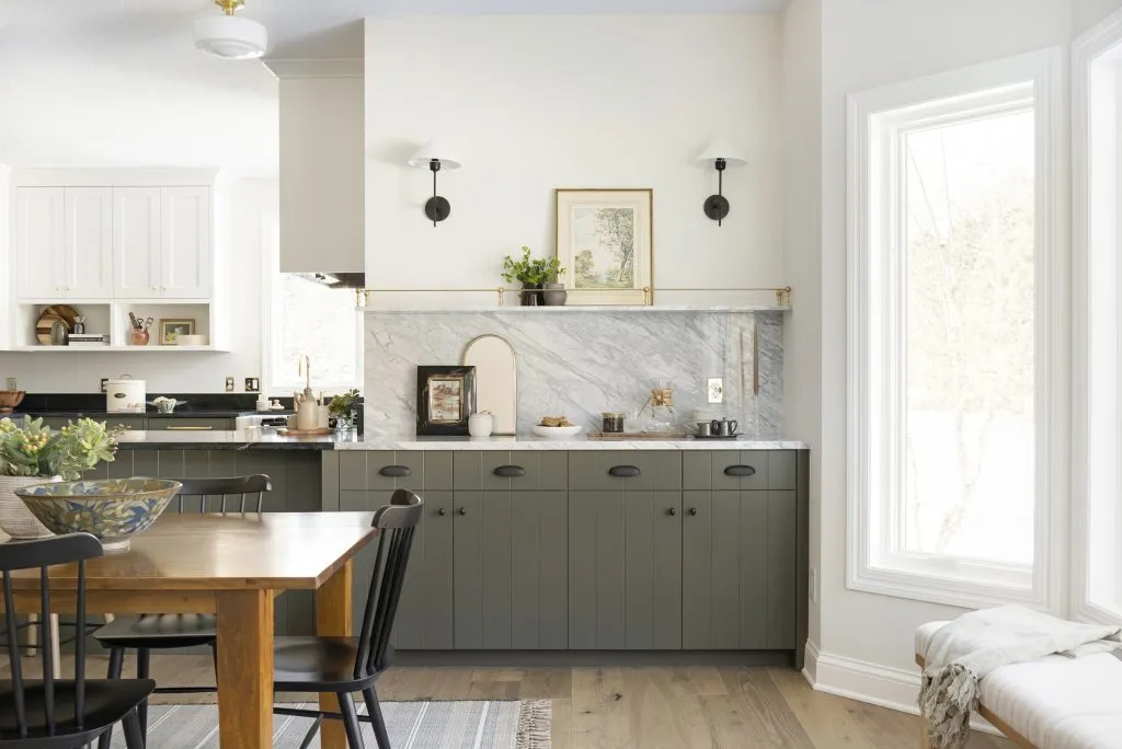 French cafe inspired coffee station, gold metal shelving detail, sconce lighting, natural marble countertops and backsplash.