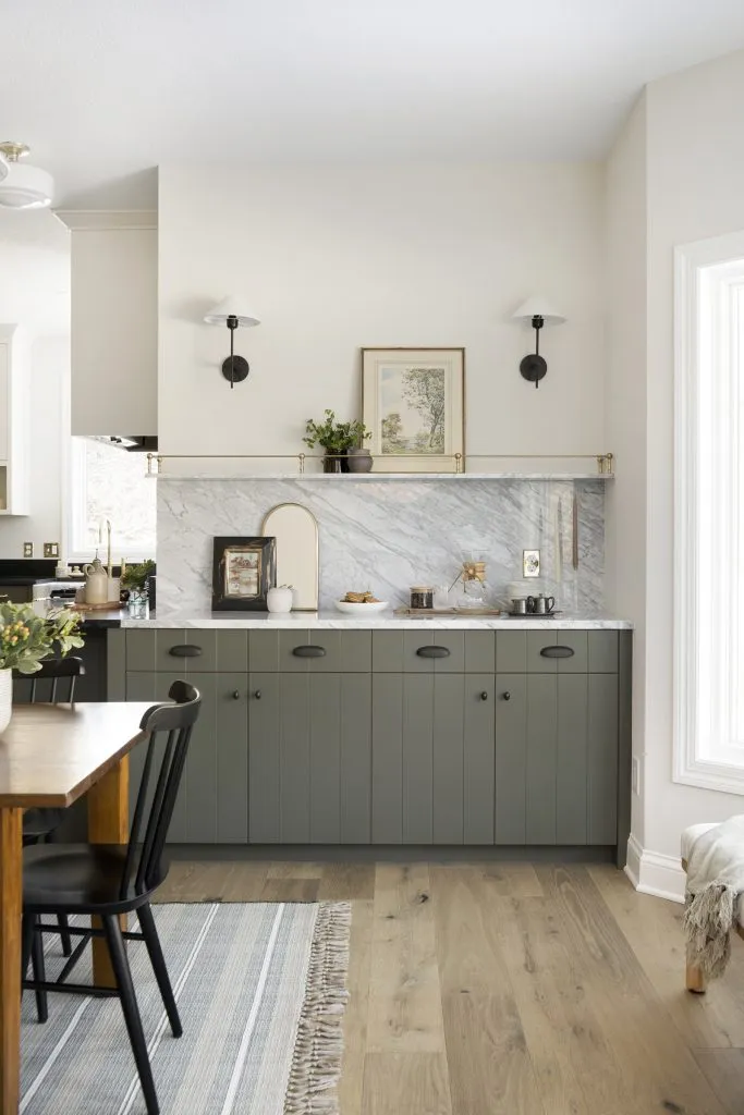 French cafe inspired coffee station, gold metal shelving detail, sconce lighting, natural marble countertops and backsplash.