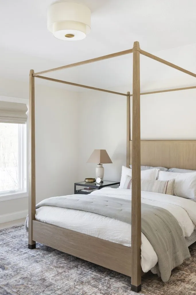 Primary bedroom with oak wood frame bed.
