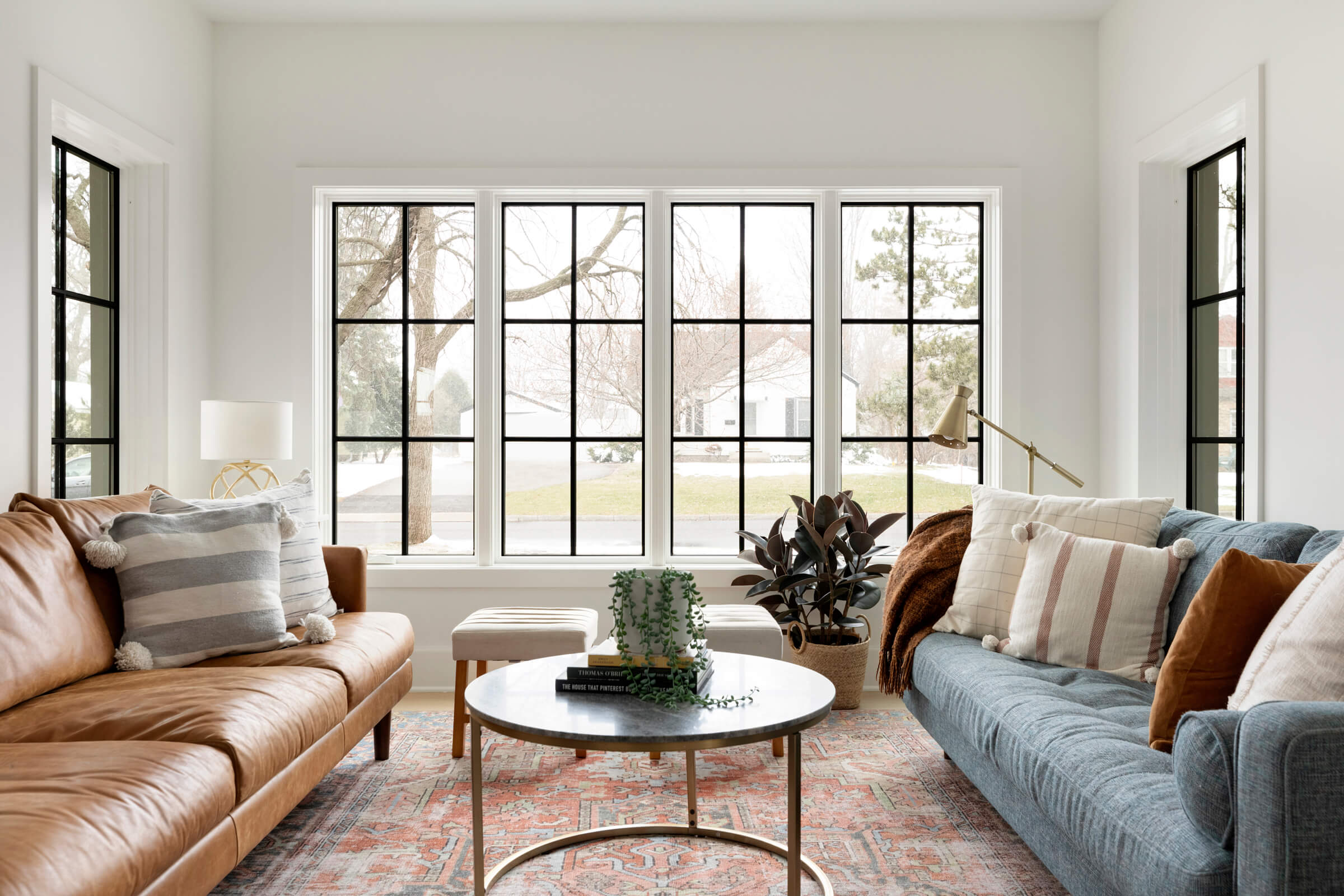 Modern Farmhouse Inspired Dining and Living Room, white oak flooring, custom cabinetry, black windows.