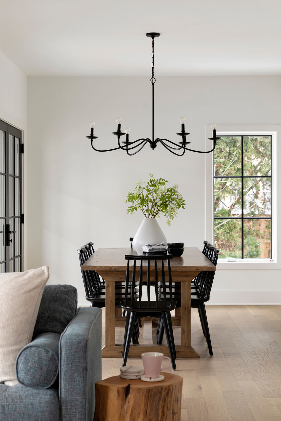 Modern Farmhouse Inspired Dining and Living Room, white oak flooring, custom cabinetry, black windows.