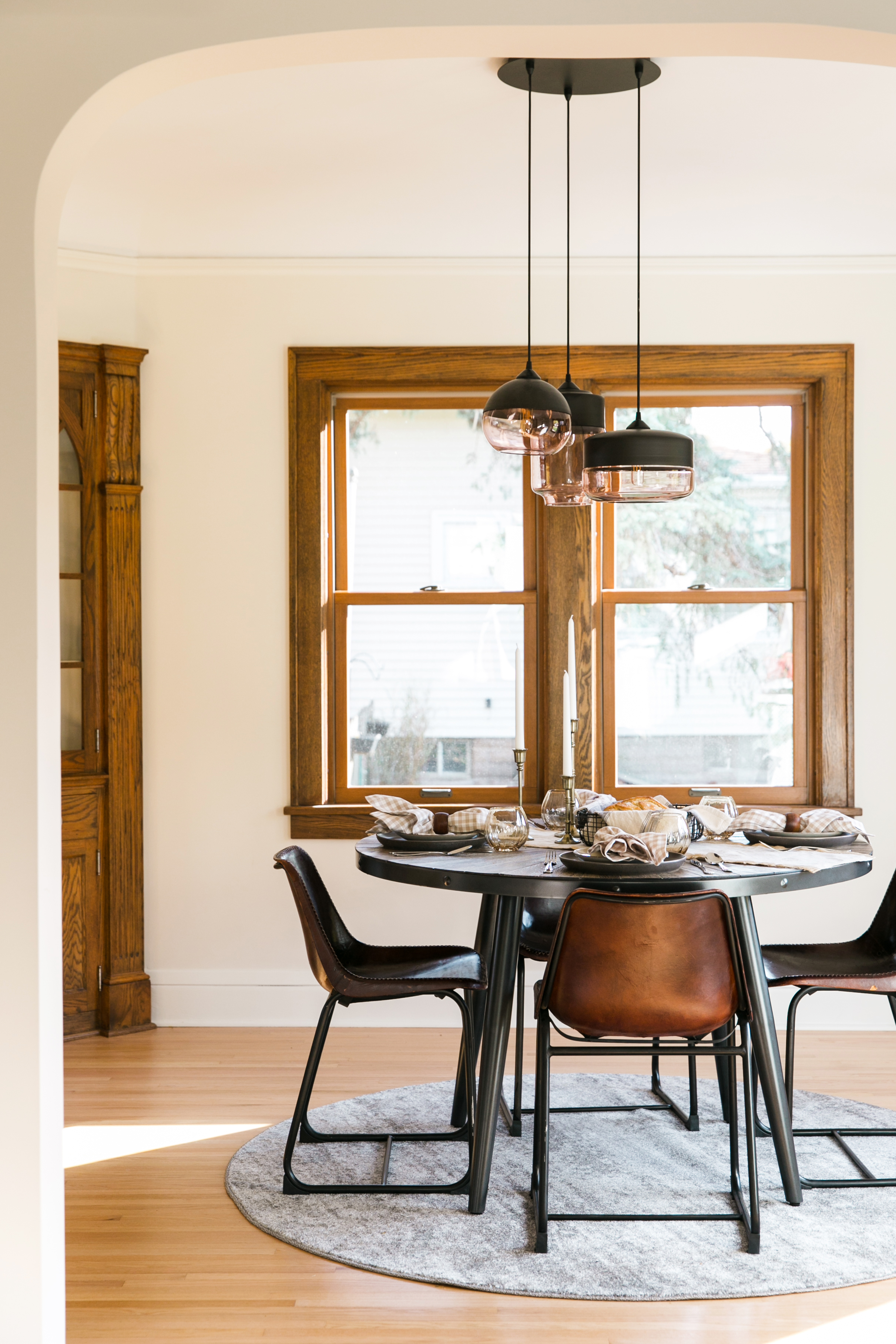 Thanksgiving table decor, hand blown glass chandelier, gingham napkins, amber wine glasses.