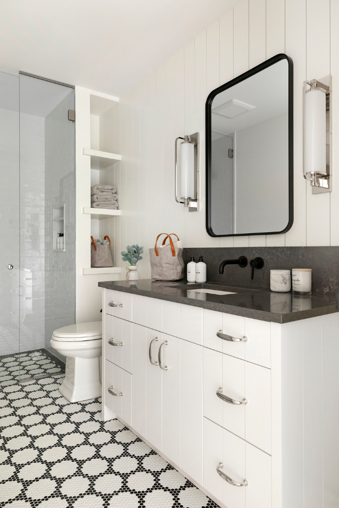 Black and white bathroom with mosaic floor tile, Jkath Murphy vanity, and quartz countertop.