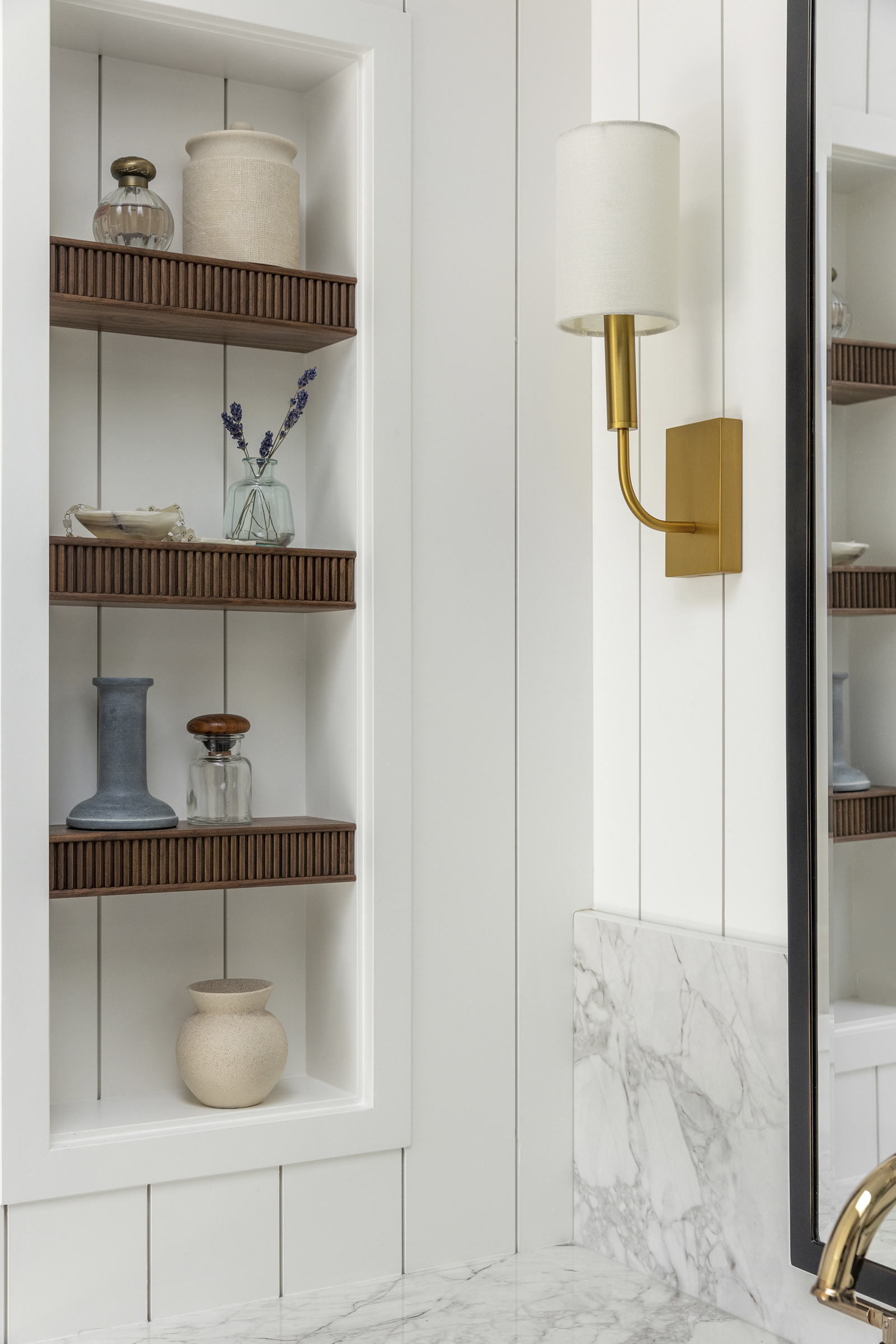 Custom walnut reeded shelves inside an owners primary bathroom suite niche