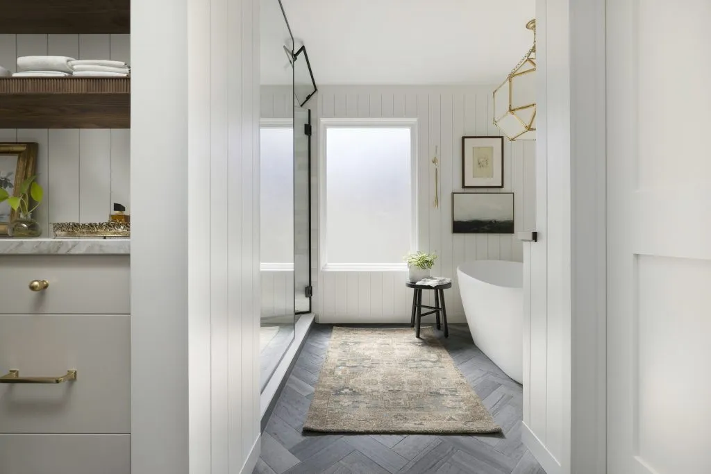Freestanding bathtub, shiplap paneled walls and handmade cafe curtains.