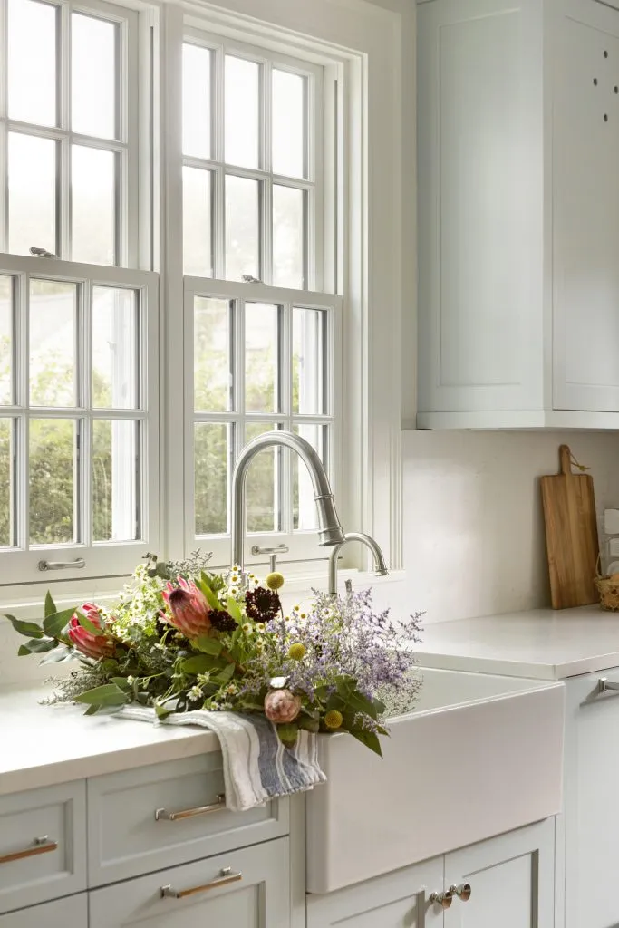 Historic kitchen renovation, light blue cabinetry, apron style sink.