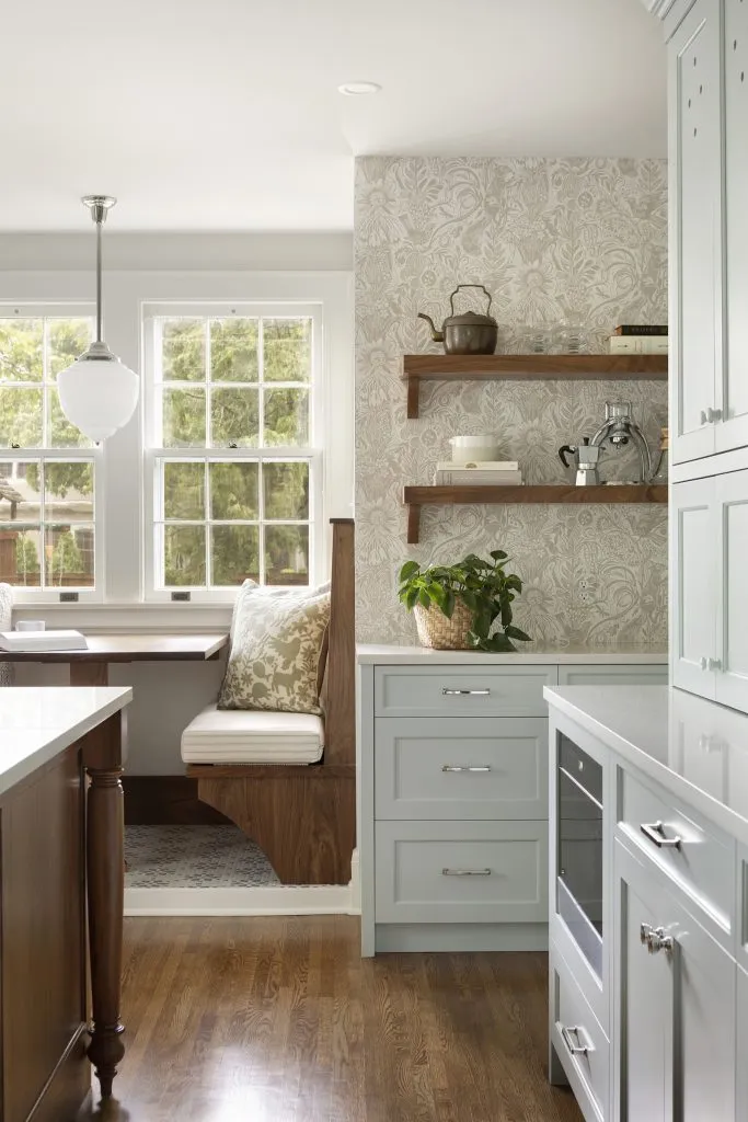 Custom built-in kitchen banquette in 1920s Colonial style home with wallpaper coffee station bar.