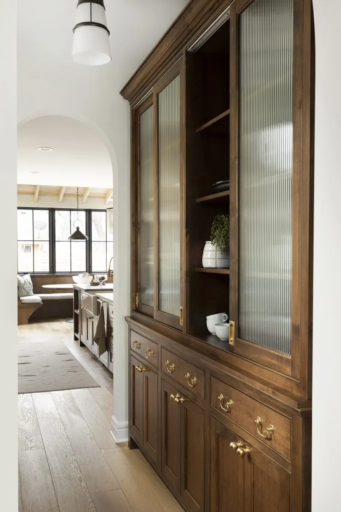 Alder wood custom pantry cabinetry. Unlacquered brass cabinetry hardware, reeded glass.