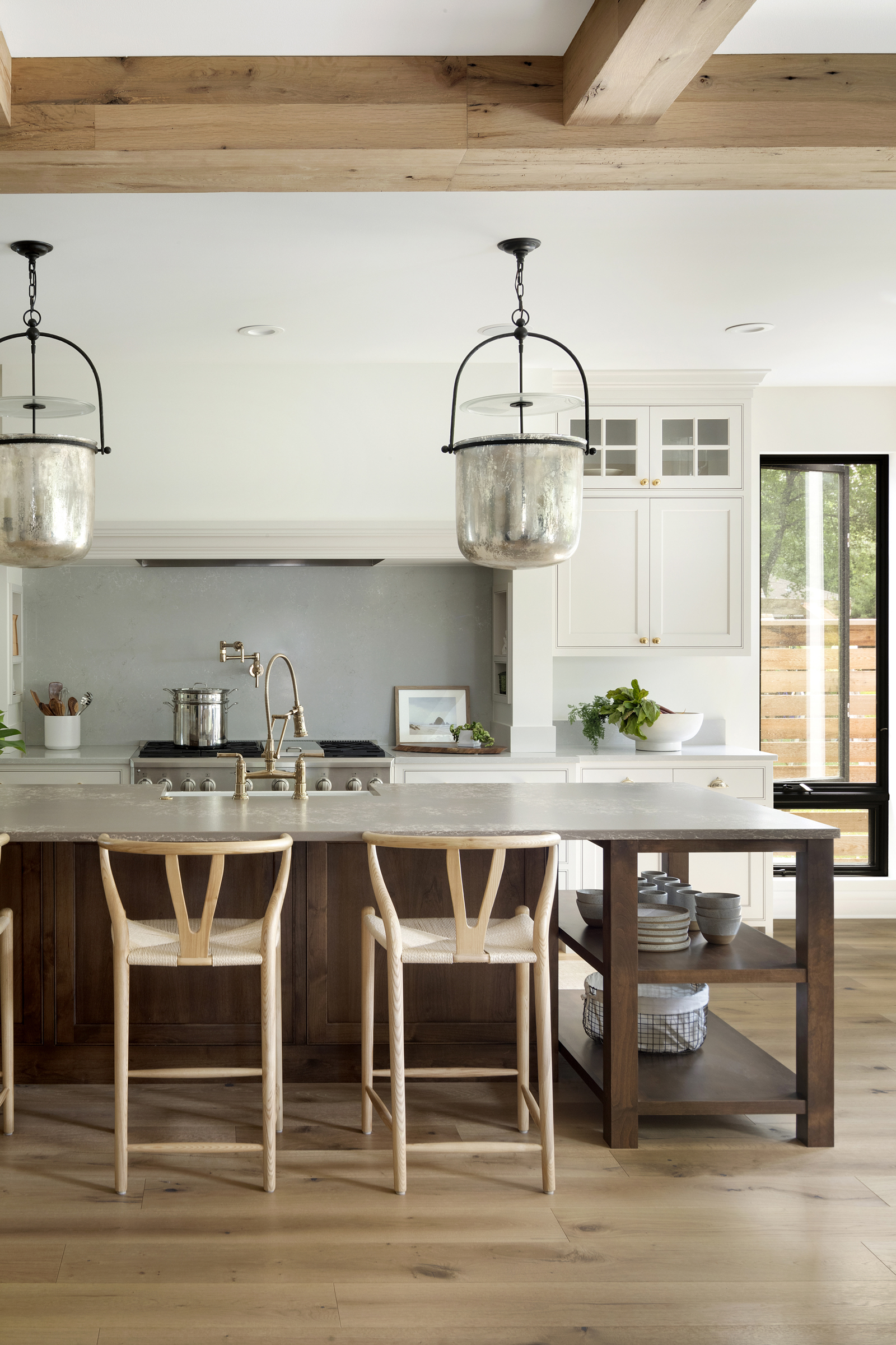 Kitchen renovation, reclaimed wood beams, oversized island lighting, quartz backsplash and dark stained wood island.