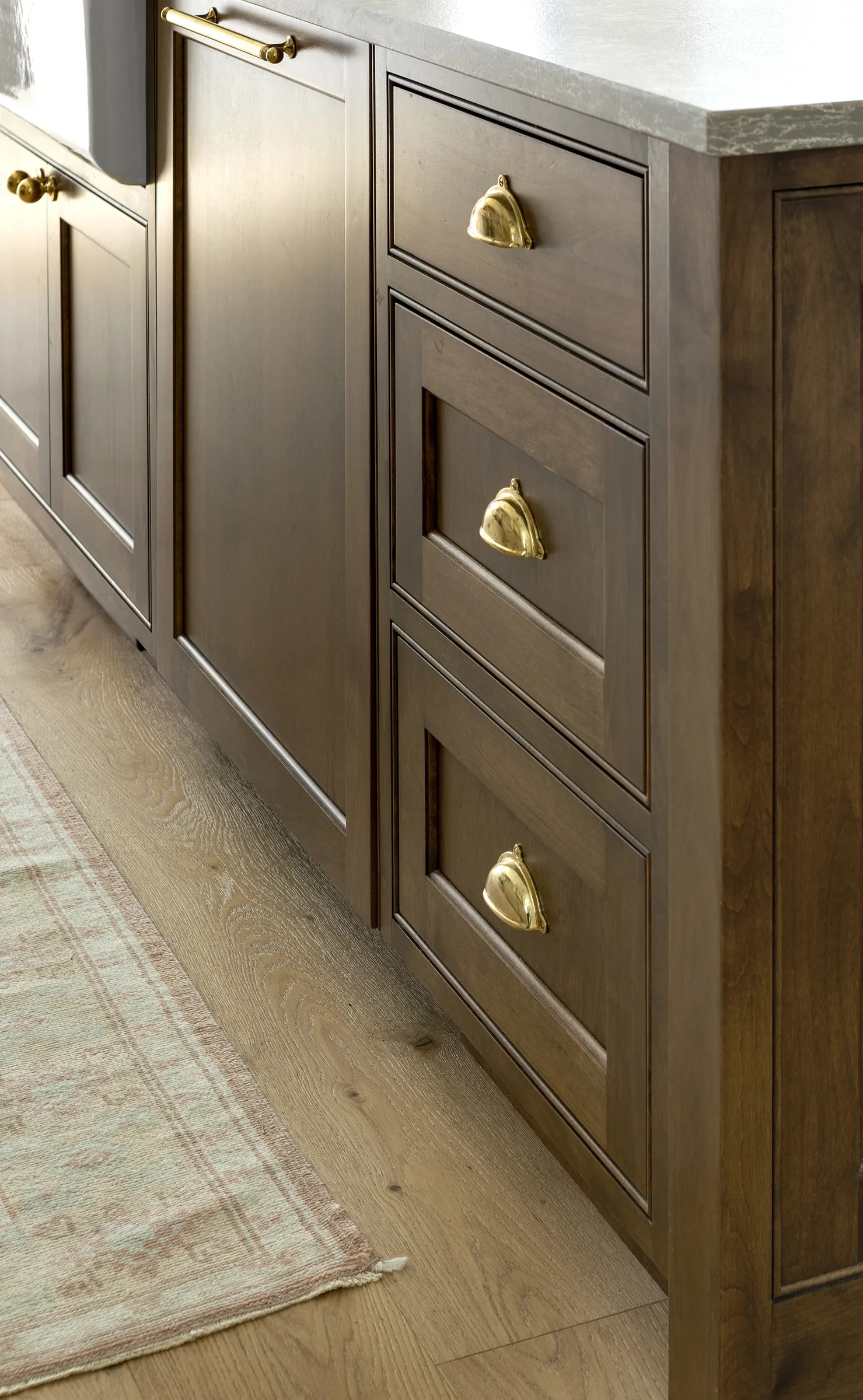 Alder wood kitchen island, integrated refrigerator with apron sink.