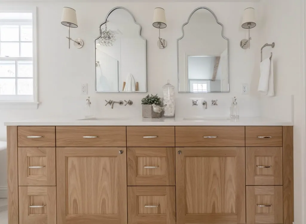 Custom oak double vanity with wall mount faucets and polished nickel accents