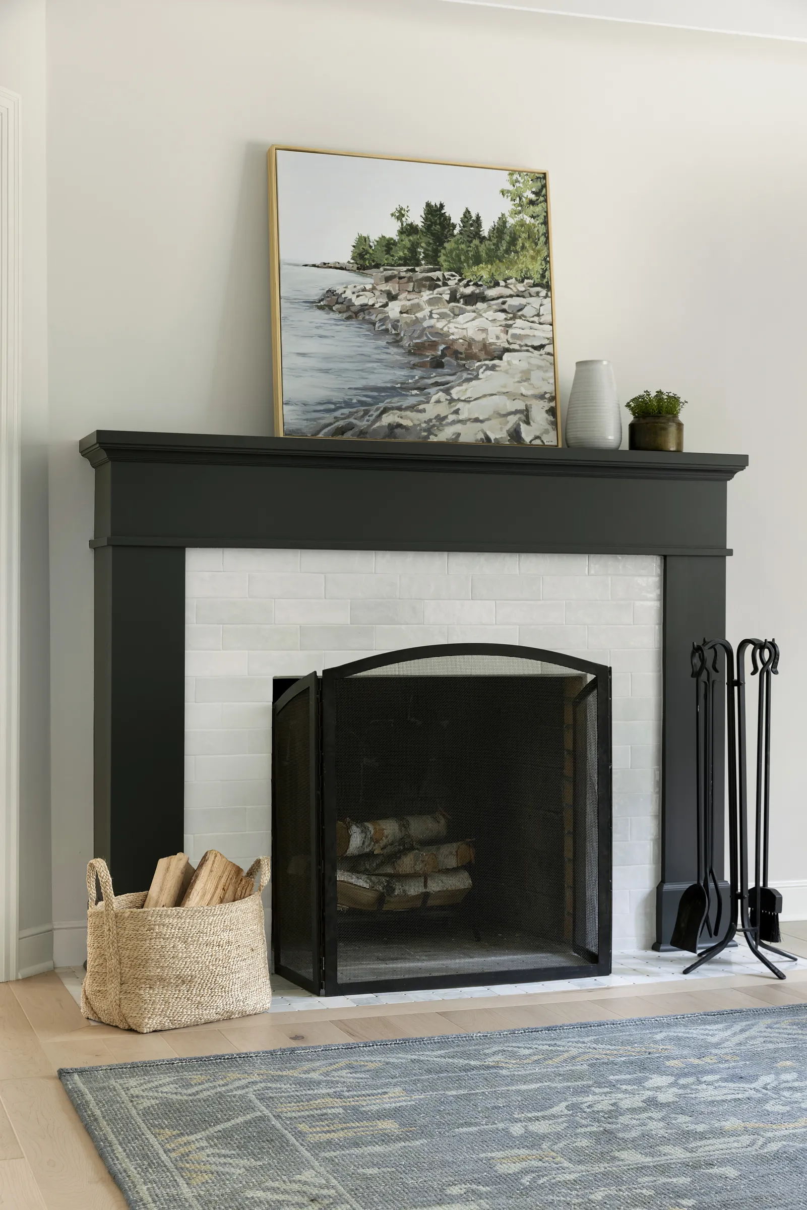 Natural stone fireplace hearth, subway tile surround and custom fireplace mantle painted dark.