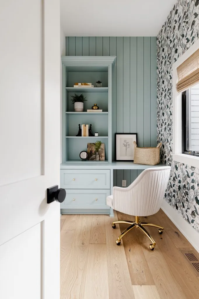 Pocket office with light blue paneling, vintage floral wallpaper.