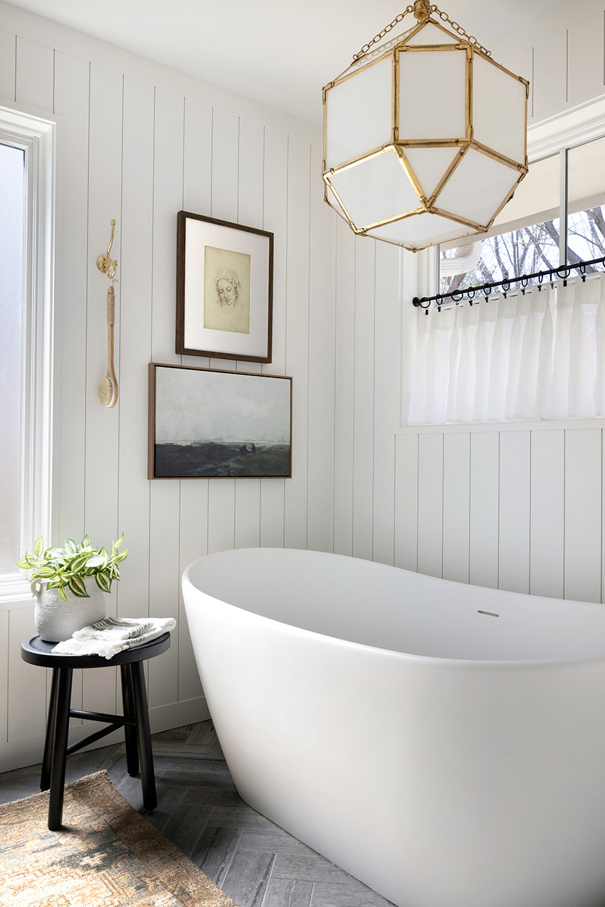 Freestanding bathtub, shiplap paneled walls and handmade cafe curtains.