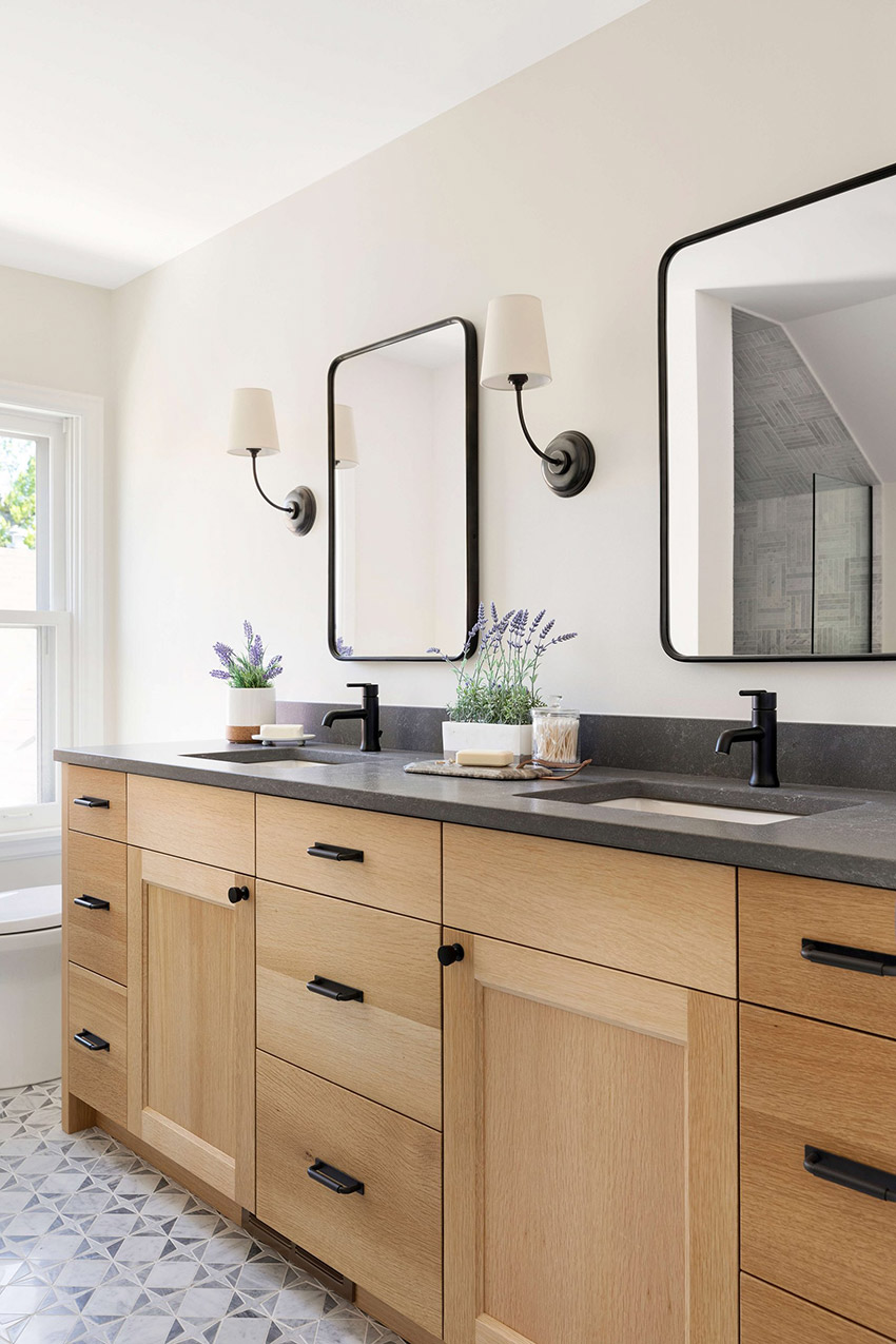 White oak double sink bathroom vanity with black cabinet hardware