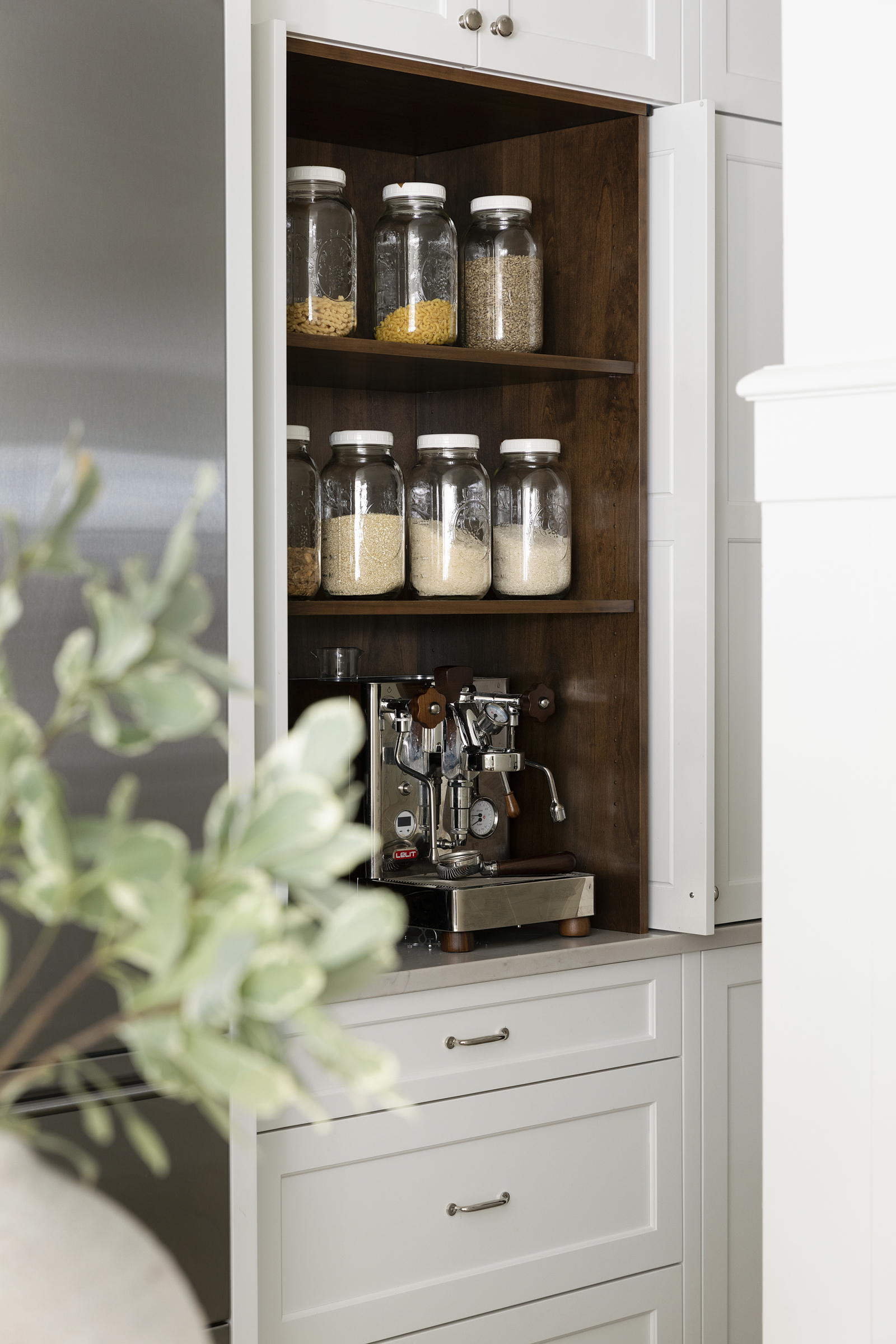 Twin Cities kitchen renovation with dark alder interior cabinet and spice jars.