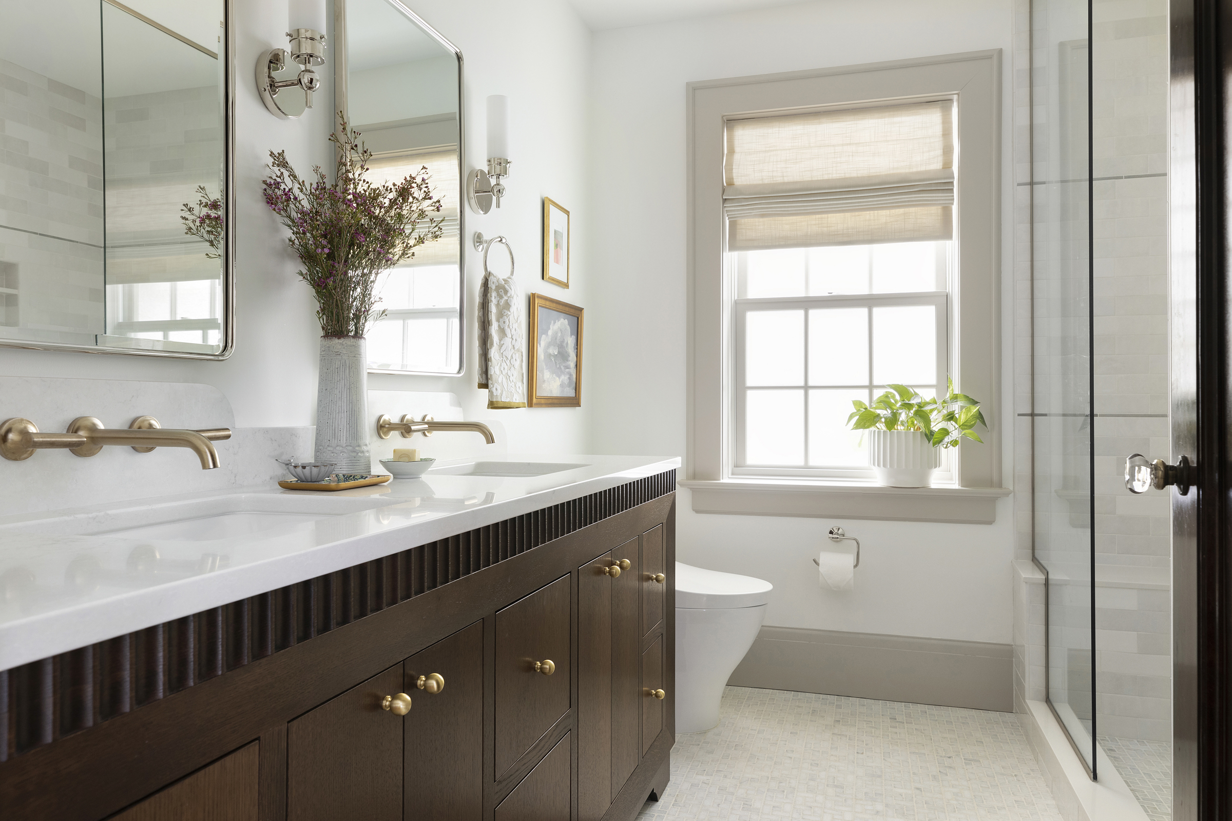 Twin Cities bathroom renovation with dark oak custom beveled vanity and mixed metals.