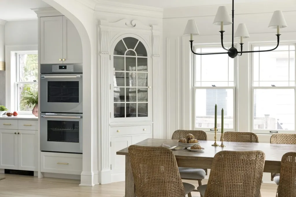 How to Refresh a 1920s Home, While Mixing Modern and Traditional Design Styles. Traditional dining room and original built in storage, enlarged arched entrance into the kitchen.