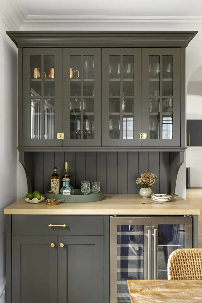 How to Refresh a 1920s Home, While Mixing Modern and Traditional Design Styles. Updated bar hutch with aged brass hardware and dark paint color.