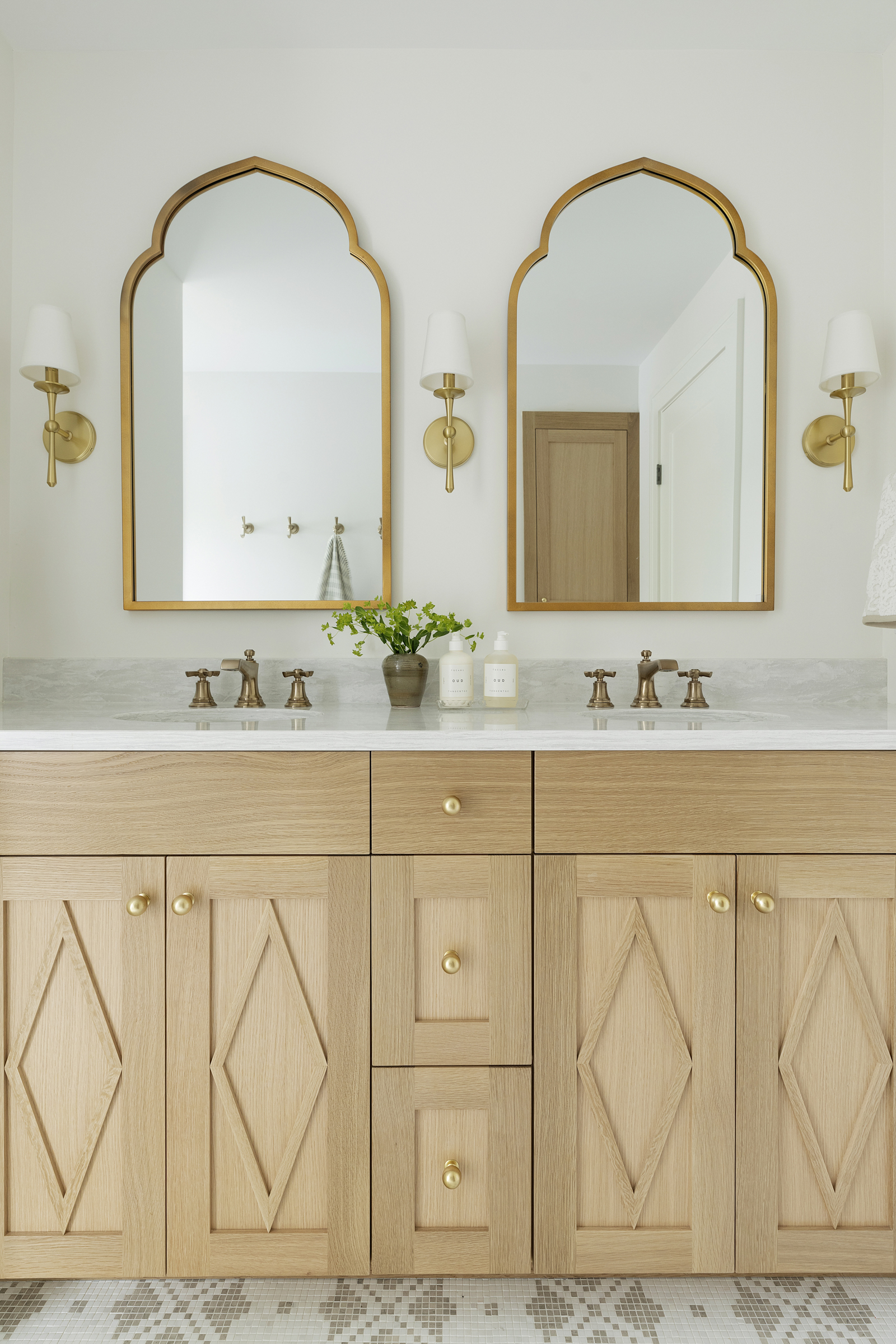 Twin Cities bathroom renovation with large white oak vanity and brass accents.