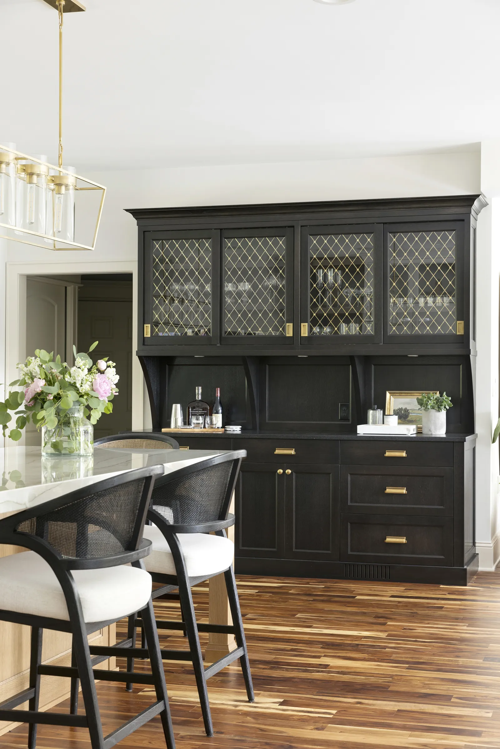 Black custom cabinetry hutch, solid brass cabinet hardware, gold mesh cabinetry insert.