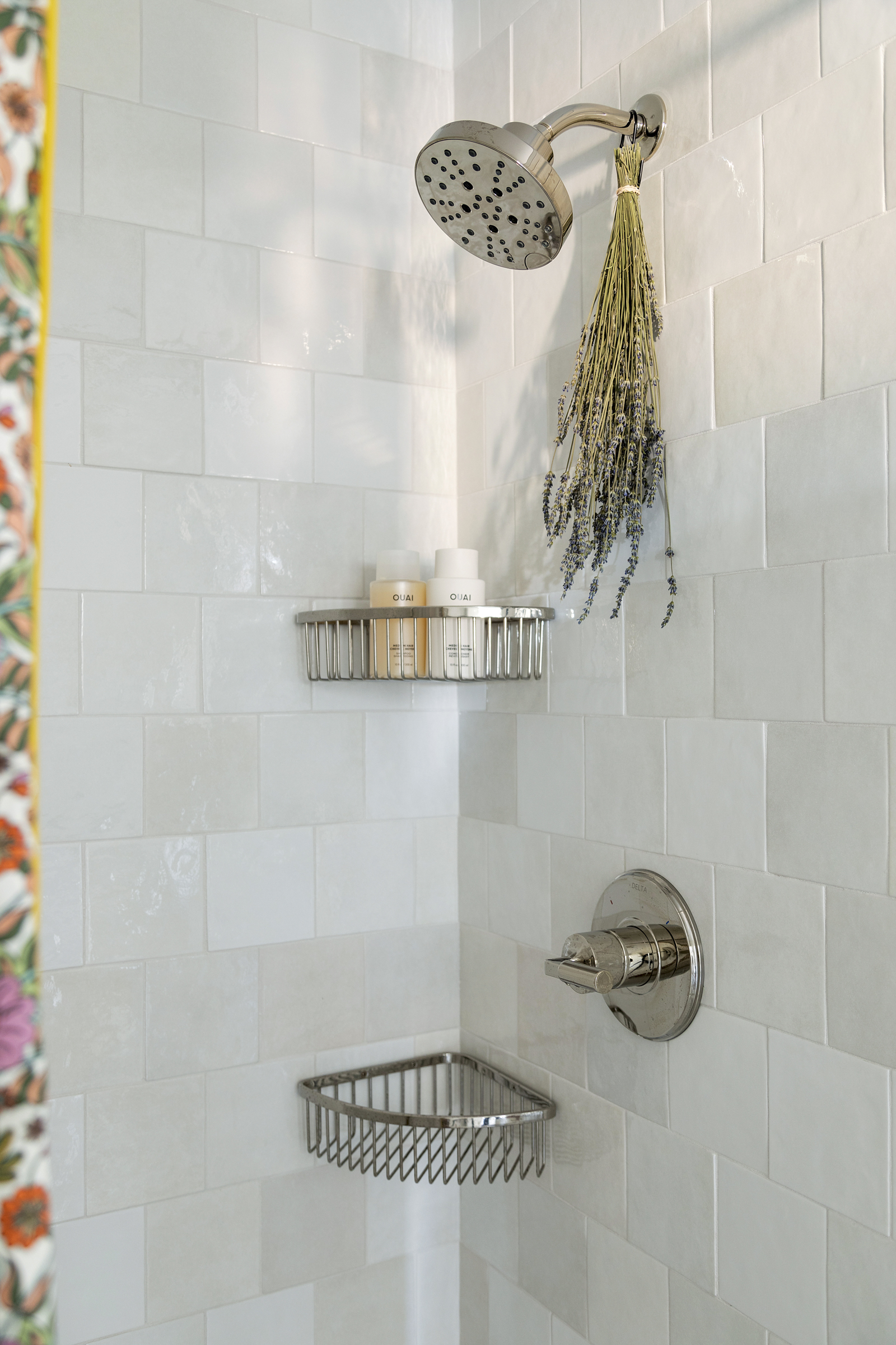 Off-white shower tile, brickiest. Polished nickel plumbing and accessories.